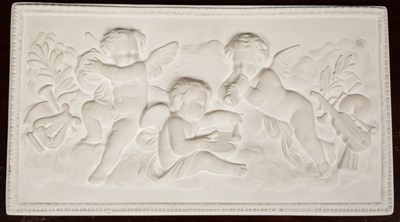 Lot 258 - A plaster plaque depicting musical cherubs,...