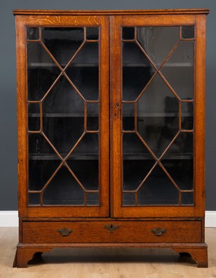 Lot 260 - A Georgian oak bookcase with twin astragal...