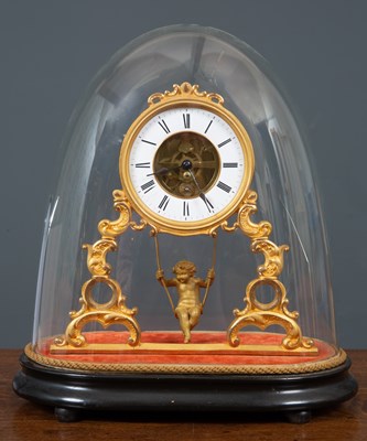 Lot 102 - A gilt clock with an enamelled dial and roman...