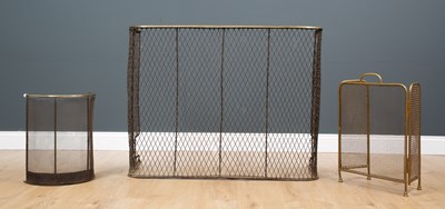 Lot 363 - A Georgian brass and wire mesh fire fender...