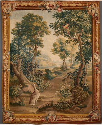 Lot 144 - An 18th century Aubusson verdure tapestry with...