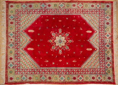 Lot 319 - An Eastern red and green ground woollen rug...