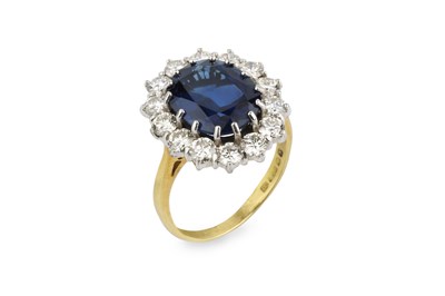 Lot 187 - A sapphire and diamond cluster ring, the oval...