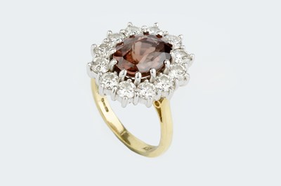 Lot 160 - A zircon and diamond cluster ring, the oval...