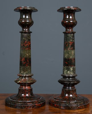 Lot 48 - A pair of serpentine marble candlesticks each...