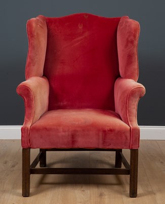 Lot 390 - A Georgian style upholstered wing back...