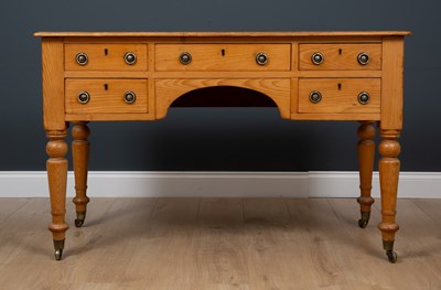 Lot 380 - A pine five drawer desk with brass ring...